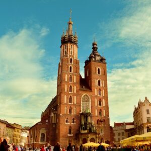 Vibrant view of St. Mary's Basilica in Krakow's bustling main square.